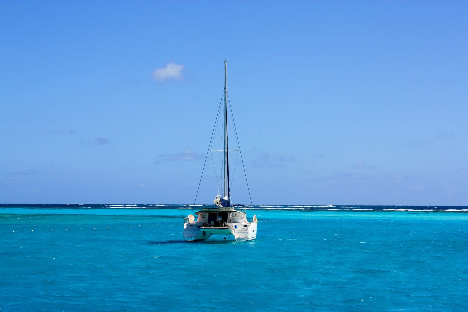Catamaran anchored in turquoise Caribbean water